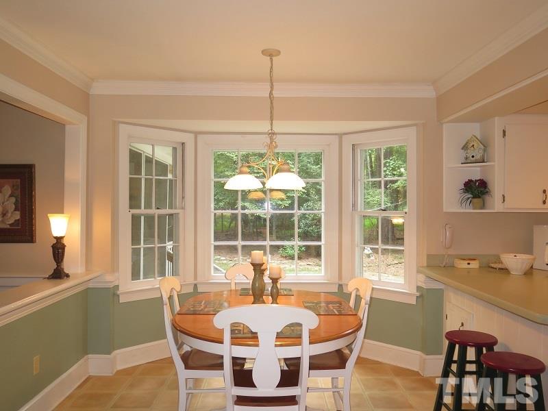 11501 Coachmans Way Raleigh, NC 27614 - Photo 8 of 20 a dining room with furniture a chandelier and wooden floor
