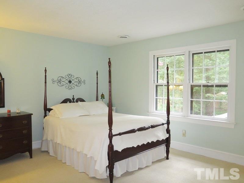 11501 Coachmans Way Raleigh, NC 27614 - Photo 10 of 20 a bed sitting in a bedroom next to a window