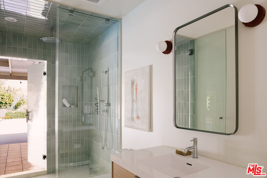 3122 Arrowhead Drive Los Angeles, CA 90068 - Photo 17 of 41 a bathroom with a shower sink and mirror