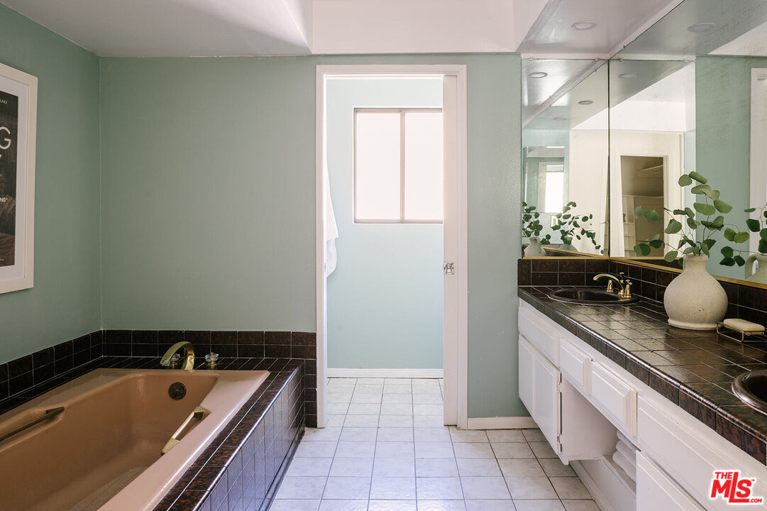 3122 Arrowhead Drive Los Angeles, CA 90068 - Photo 23 of 41 a bath room with a sink and a mirror