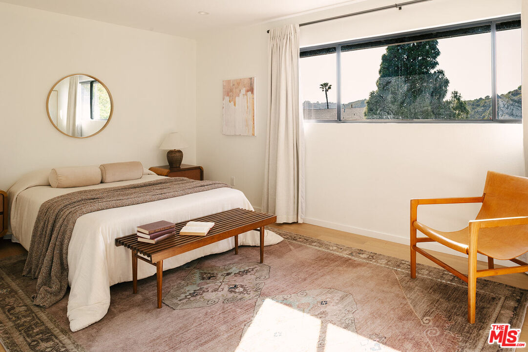 3122 Arrowhead Drive Los Angeles, CA 90068 - Photo 25 of 41 a bedroom with a bed window and a mirror
