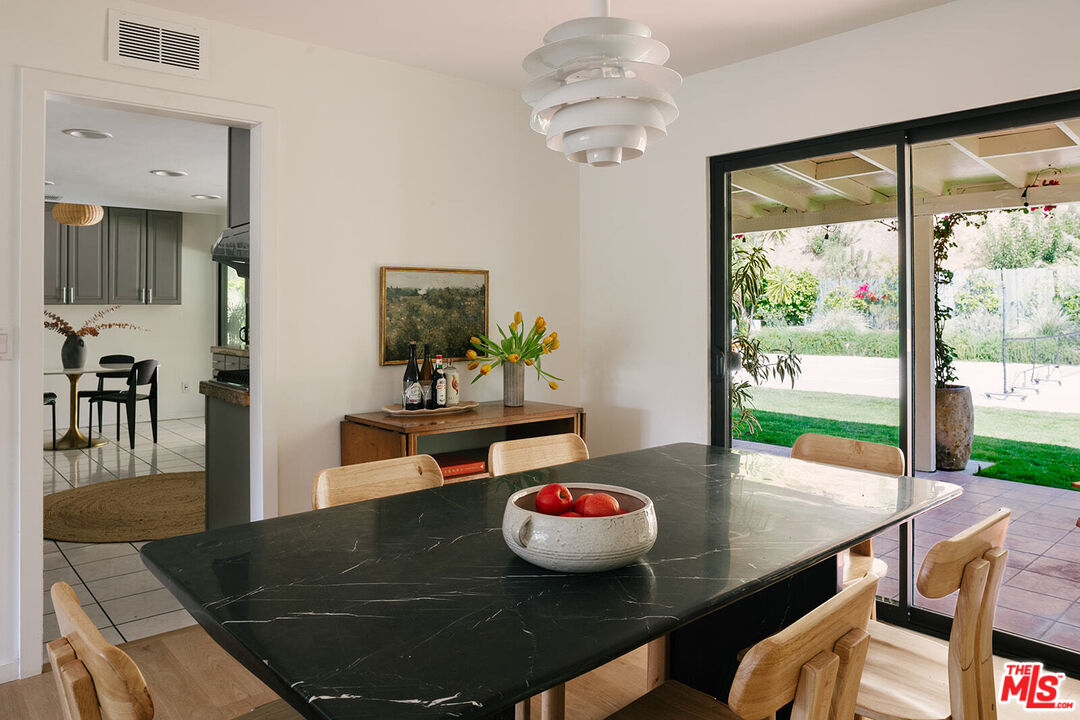 3122 Arrowhead Drive Los Angeles, CA 90068 - Photo 7 of 41 a view of a dining room with furniture wooden floor and a chandelier
