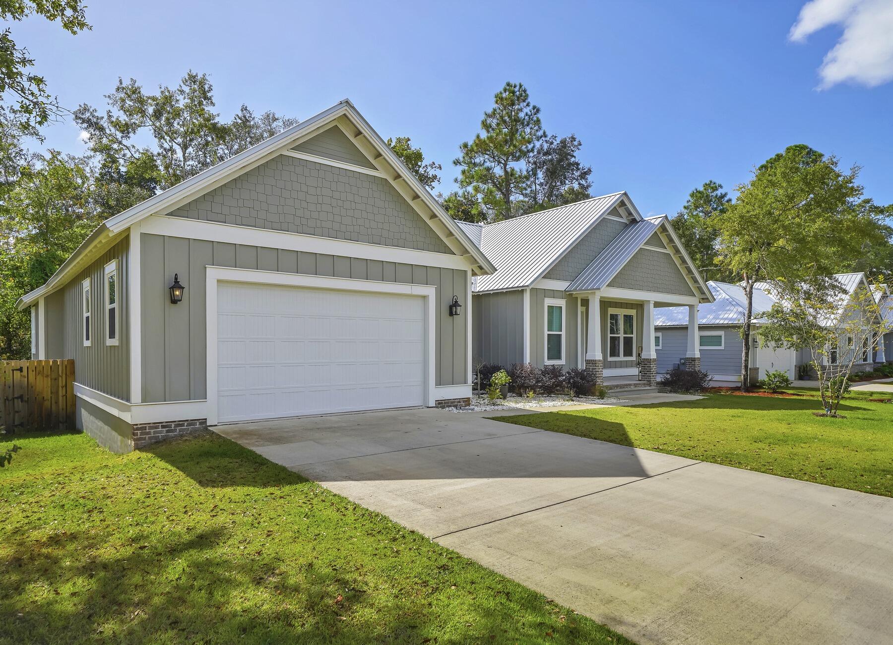 15 Hibernate Way Freeport, FL 32439 - Photo 1 of 38 a front view of a house with a yard and garage