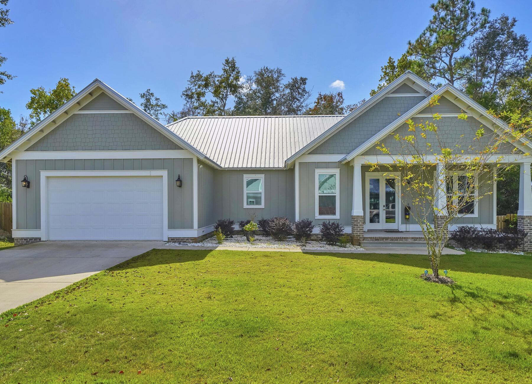 15 Hibernate Way Freeport, FL 32439 - Photo 2 of 38 a front view of a house with a yard and porch