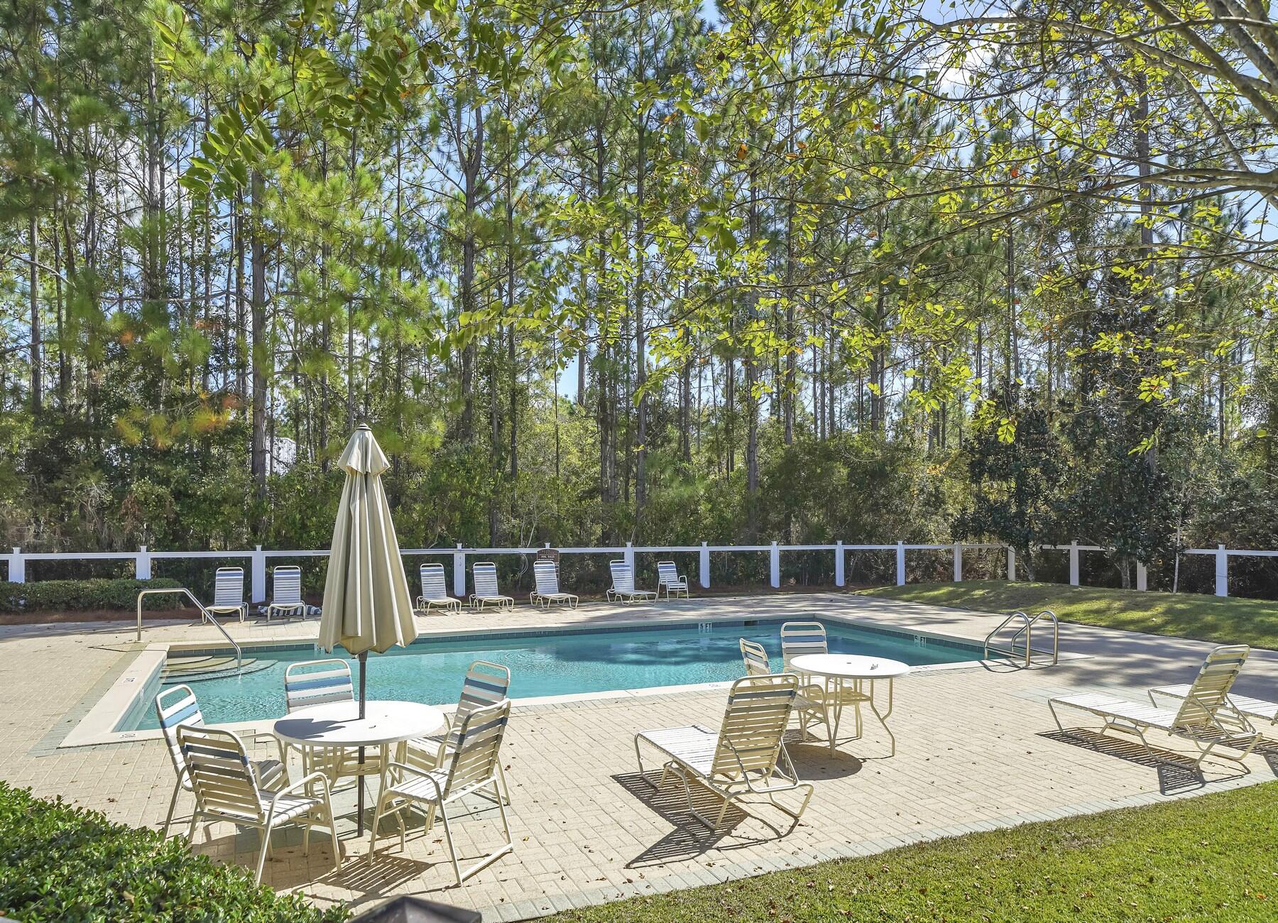 15 Hibernate Way Freeport, FL 32439 - Photo 34 of 38 a view of swimming pool with table and chairs