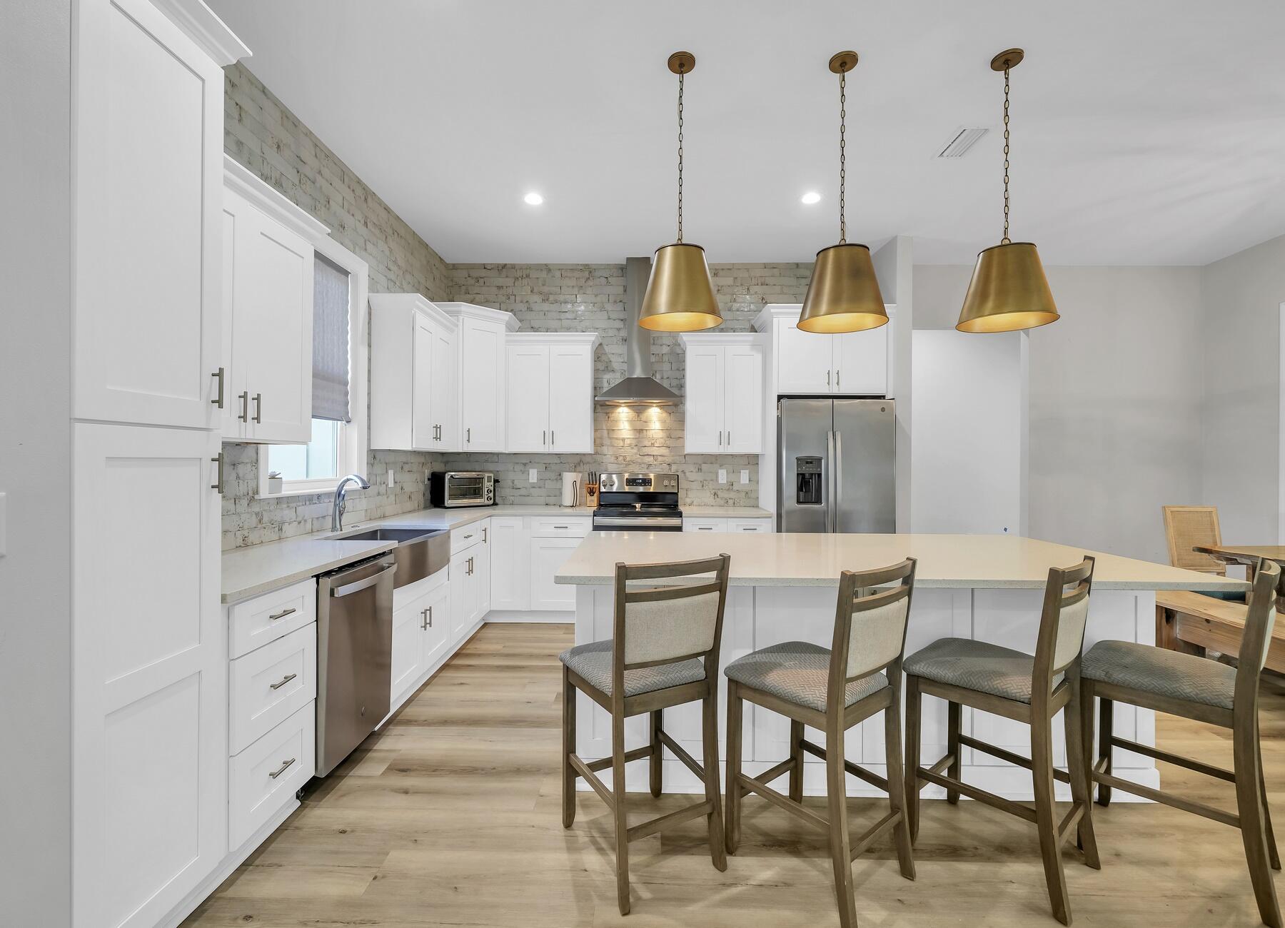 15 Hibernate Way Freeport, FL 32439 - Photo 10 of 38 a view of kitchen with stainless steel appliances kitchen island granite countertop a table and chairs