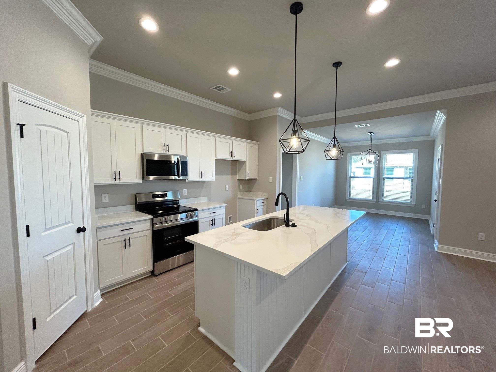877 Sumter Loop Foley, AL 36535 - Photo 2 of 18 Kitchen featuring white cabinets, stainless steel appliances, wood tiled floor, and a sink