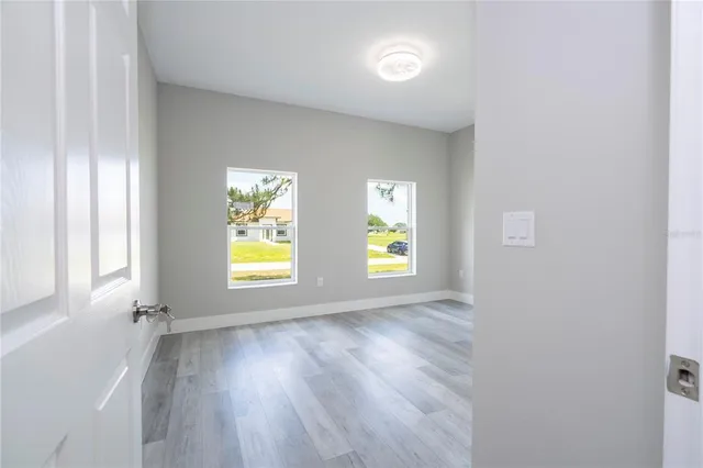 a view of a room with wooden floor