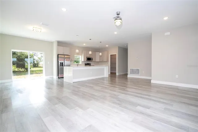a view of kitchen with cabinets and wooden floor