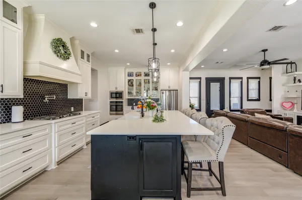 a large kitchen with a table and chairs