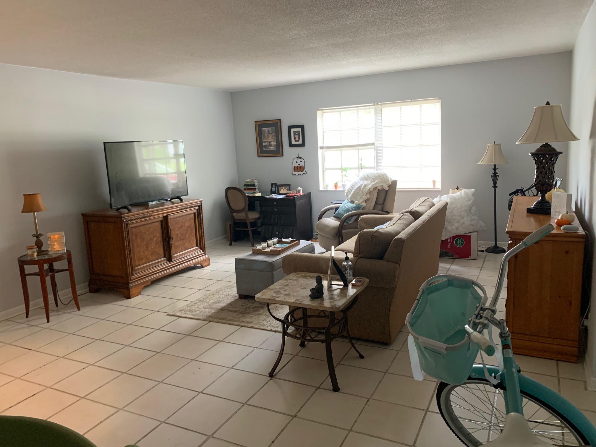1798 Northwest 15th Vista, Unit 5 Boca Raton, FL 33432 - Photo 13 of 15 a living room with furniture a flat screen tv and a window