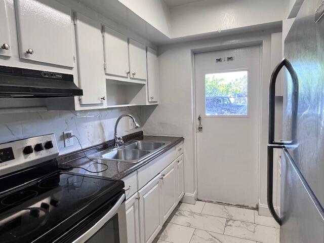 1798 Northwest 15th Vista, Unit 5 Boca Raton, FL 33432 - Photo 5 of 15 a kitchen with a sink appliances and cabinets