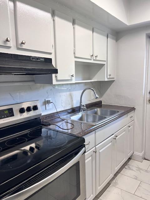 1798 Northwest 15th Vista, Unit 5 Boca Raton, FL 33432 - Photo 6 of 15 a kitchen with a sink cabinets and stainless steel appliances