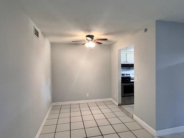 1798 Northwest 15th Vista, Unit 5 Boca Raton, FL 33432 - Photo 8 of 15 a view of an empty room with a ceiling fan and window