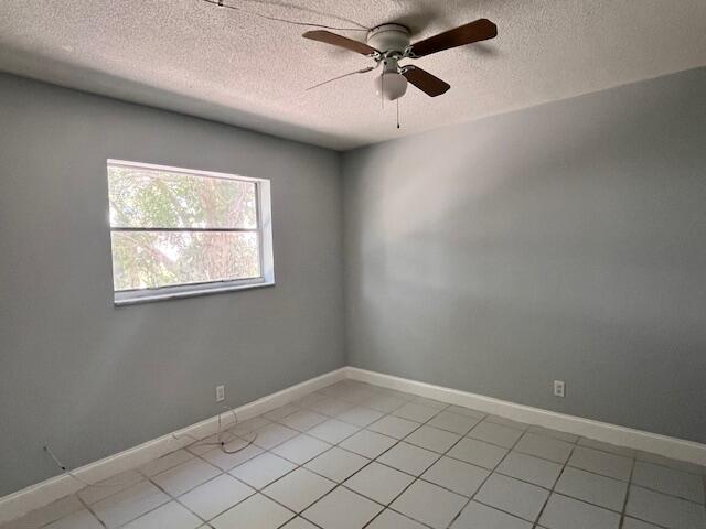 1798 Northwest 15th Vista, Unit 5 Boca Raton, FL 33432 - Photo 9 of 15 an empty room with windows and fan