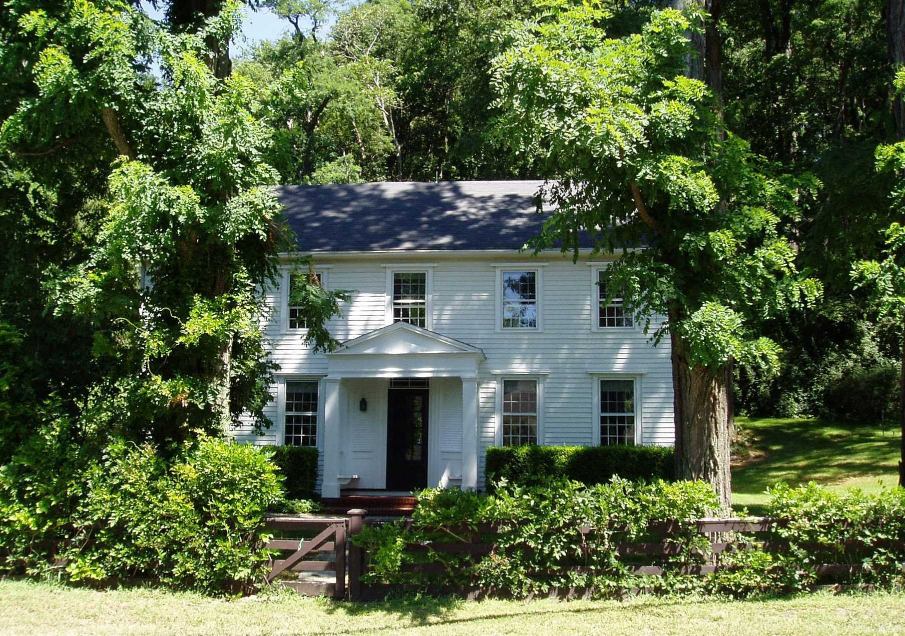 a front view of house with a garden