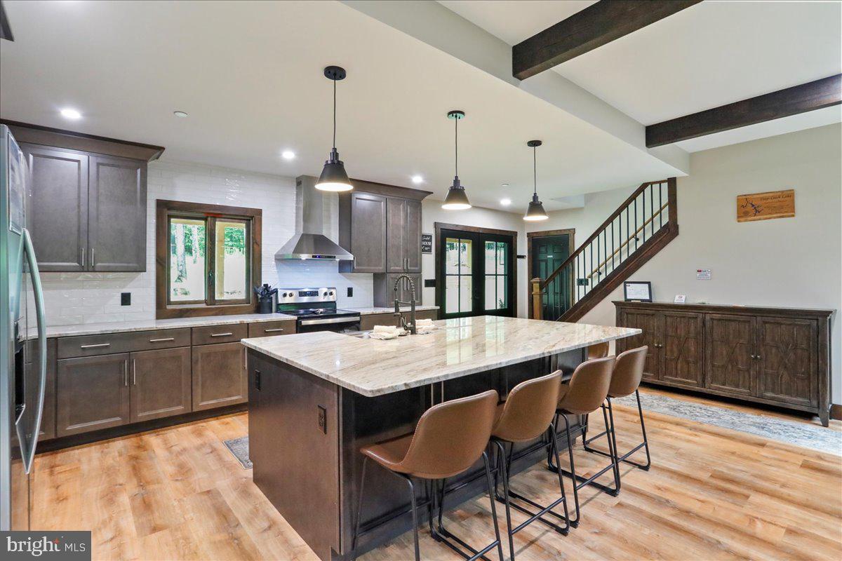 130 Lodestone Way Oakland, MD 21550 - Photo 11 of 47 a kitchen with stainless steel appliances granite countertop a kitchen island a stove a table and chairs