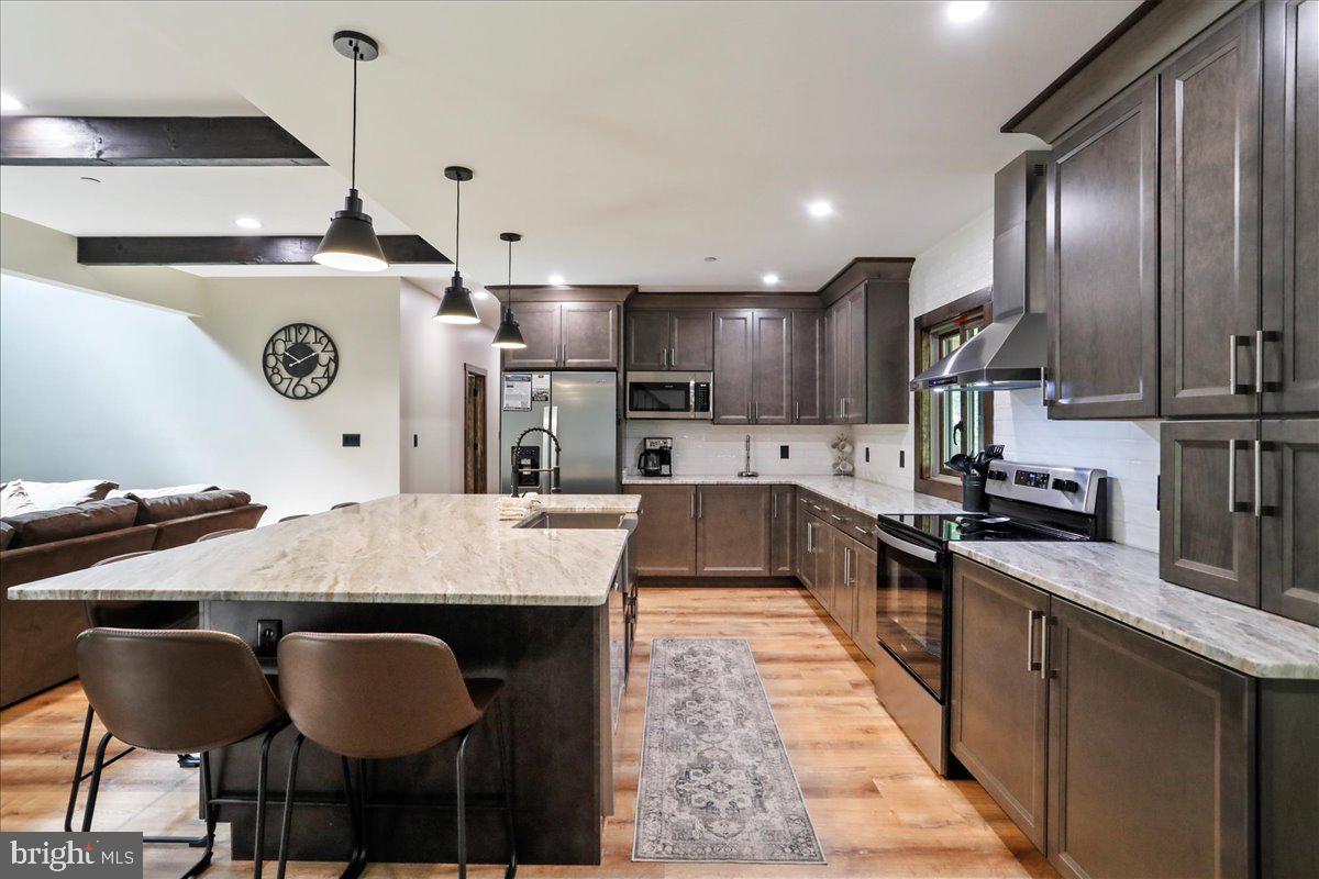 130 Lodestone Way Oakland, MD 21550 - Photo 12 of 47 a large kitchen with lots of counter space and stainless steel appliances
