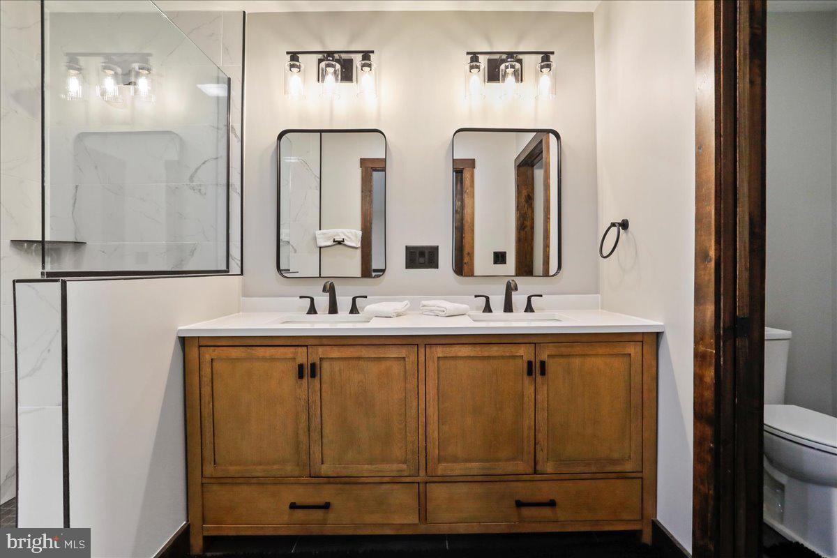 130 Lodestone Way Oakland, MD 21550 - Photo 32 of 47 a bathroom with 2 sink and a mirror