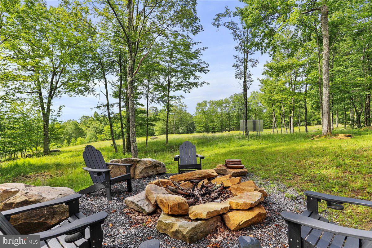 130 Lodestone Way Oakland, MD 21550 - Photo 38 of 47 a view of a garden with lawn chairs and a yard