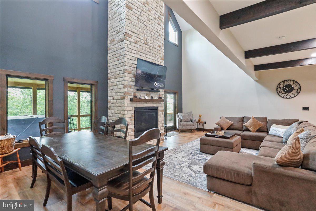 130 Lodestone Way Oakland, MD 21550 - Photo 6 of 47 a living room with furniture a fireplace and a large window