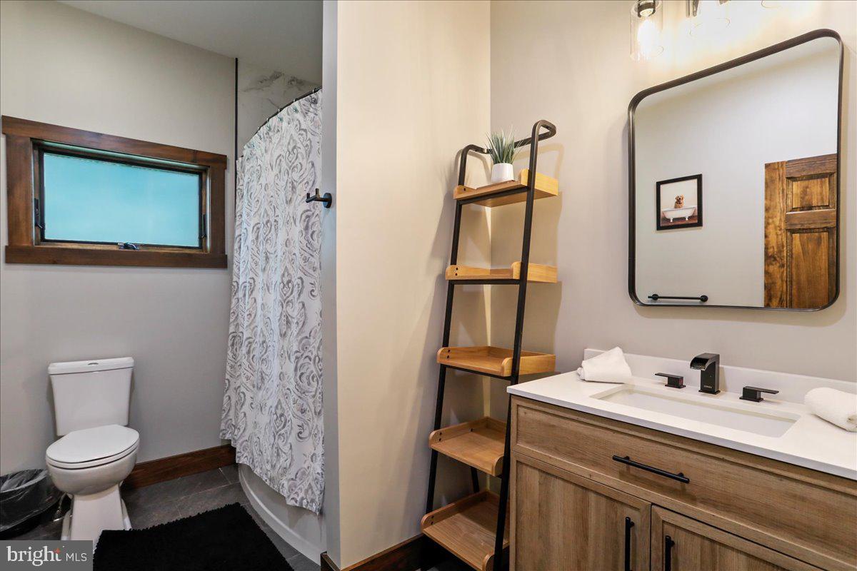 130 Lodestone Way Oakland, MD 21550 - Photo 7 of 47 a bathroom with a toilet sink and mirror