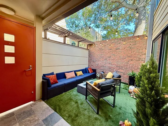 a backyard of a house with outdoor seating