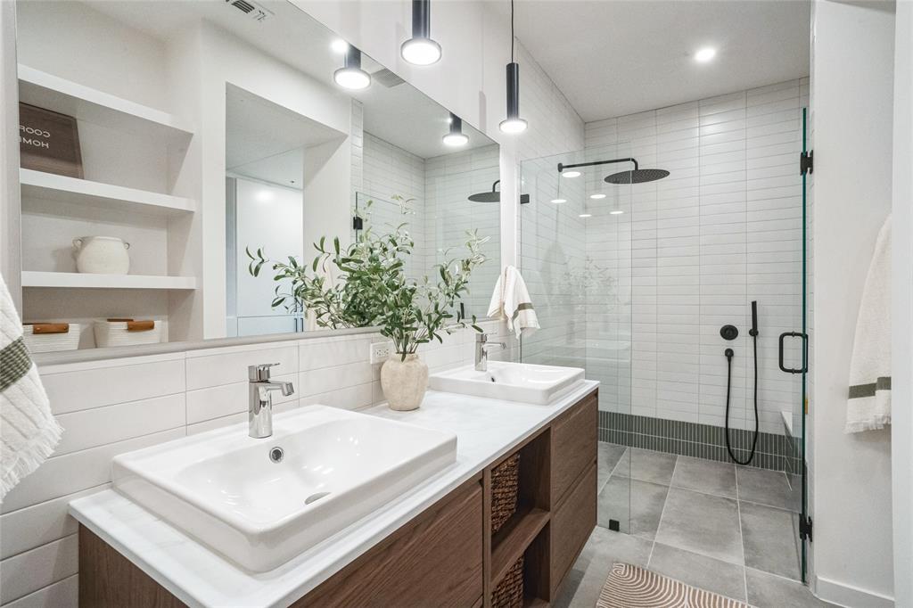 700 Denson Drive, Unit 1102 Austin, TX 78752 - Photo 16 of 30 a bathroom with a sink and a mirror