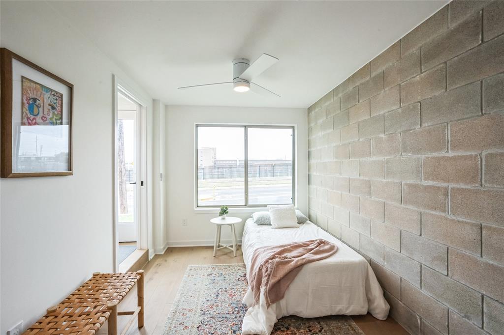 700 Denson Drive, Unit 1102 Austin, TX 78752 - Photo 17 of 30 a bedroom with a bed and a window