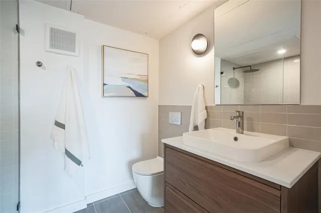 a bedroom with a bed and a potted plant