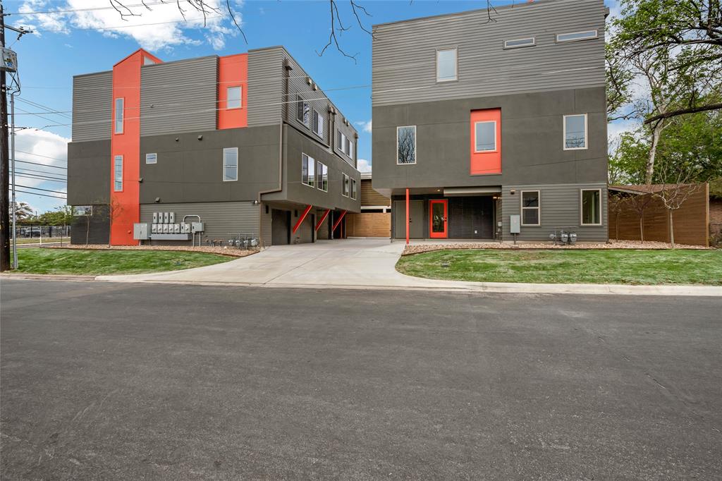 700 Denson Drive, Unit 1102 Austin, TX 78752 - Photo 25 of 30 a front view of a house with a yard and garage
