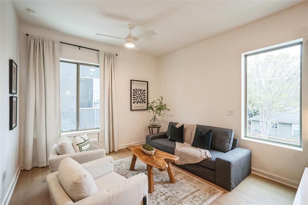 700 Denson Drive, Unit 1102 Austin, TX 78752 - Photo 3 of 30 a living room with furniture and a window