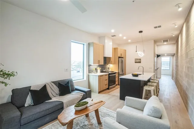 a living room with furniture and kitchen view