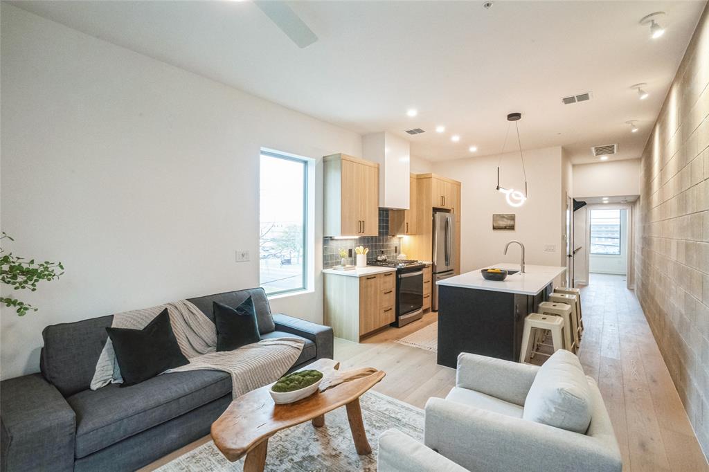 700 Denson Drive, Unit 1102 Austin, TX 78752 - Photo 4 of 30 a living room with furniture and kitchen view
