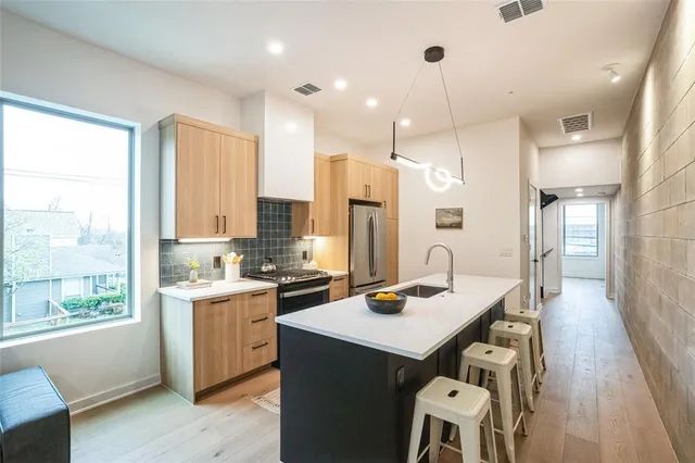 a living room with furniture and a view of kitchen