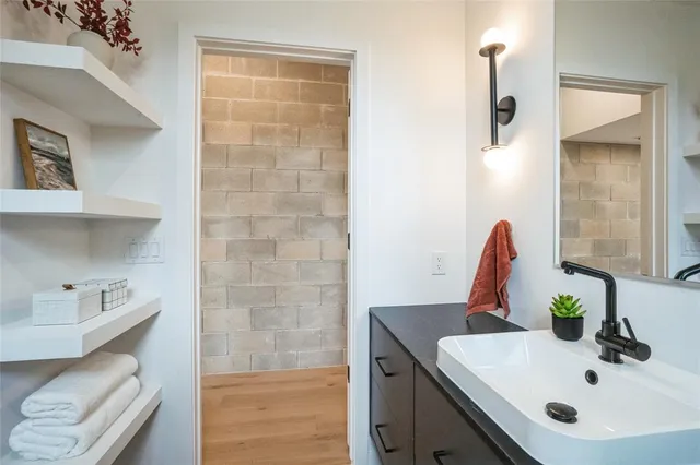 a bathroom with a double vanity sink toilet and shower