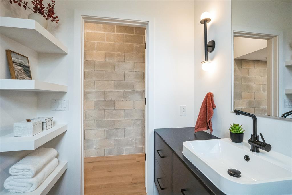 700 Denson Drive, Unit 1102 Austin, TX 78752 - Photo 8 of 30 a bathroom with a sink toilet and vanity