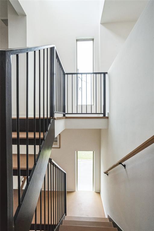 700 Denson Drive, Unit 1102 Austin, TX 78752 - Photo 9 of 30 a view of staircase with wooden floor and a window