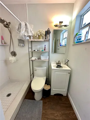 a bathroom with a sink toilet and shower