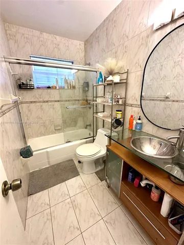 a bathroom with a sink a mirror and a toilet