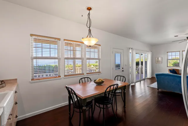 a view of a dining room with furniture window and wooden floor