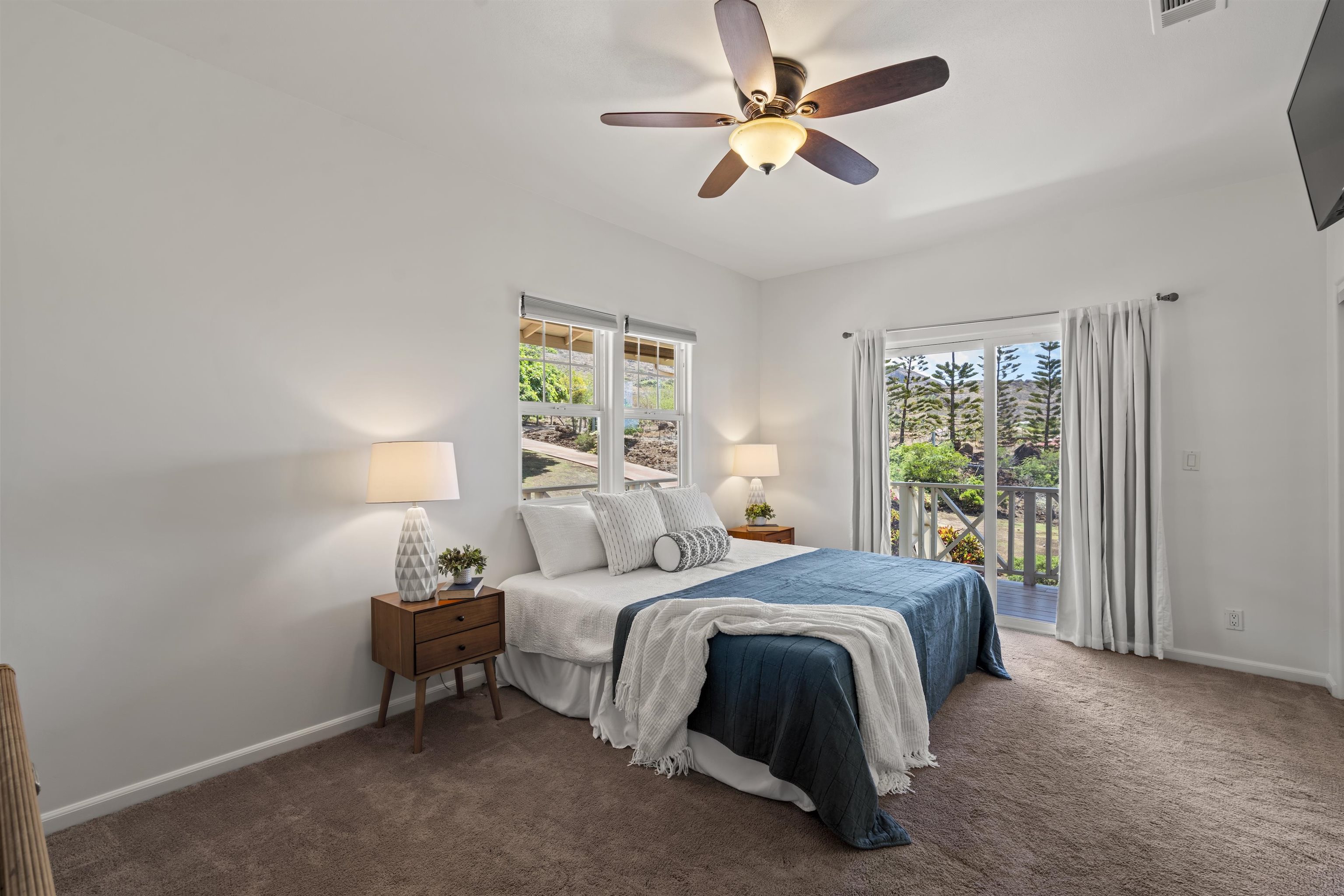 60 East Huapala Place, Unit B Lahaina, HI 96761 - Photo 13 of 50 a bedroom with a bed and a chandelier