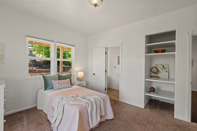 a bedroom with a bed and a window