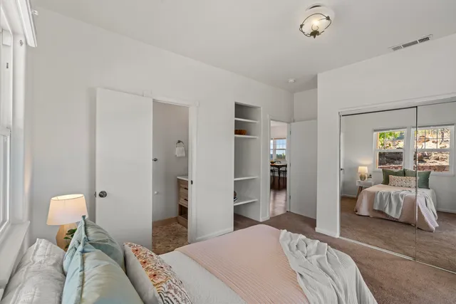 a bedroom with a bed and chair