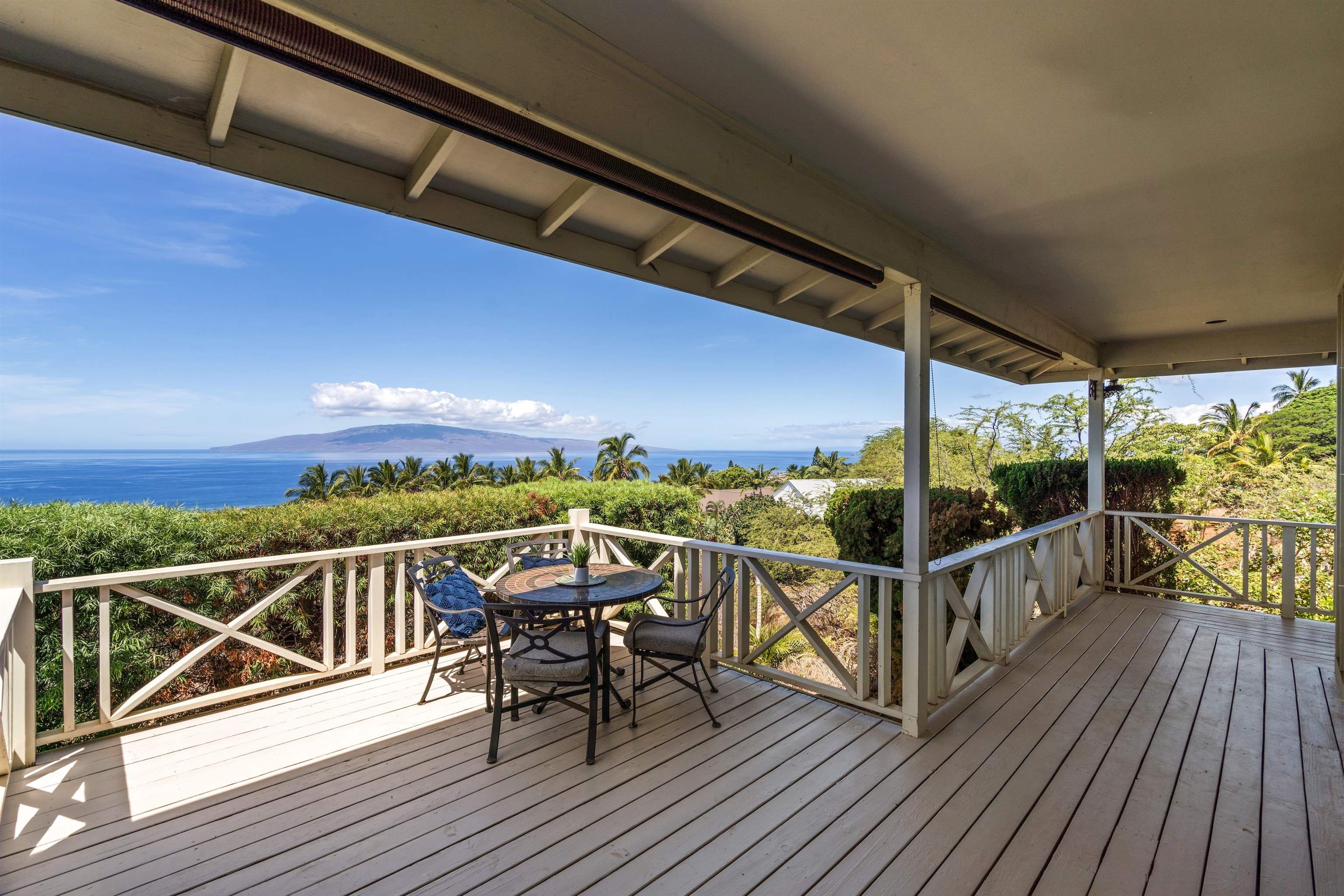 60 East Huapala Place, Unit B Lahaina, HI 96761 - Photo 21 of 50 a view of a balcony with chairs and wooden floor