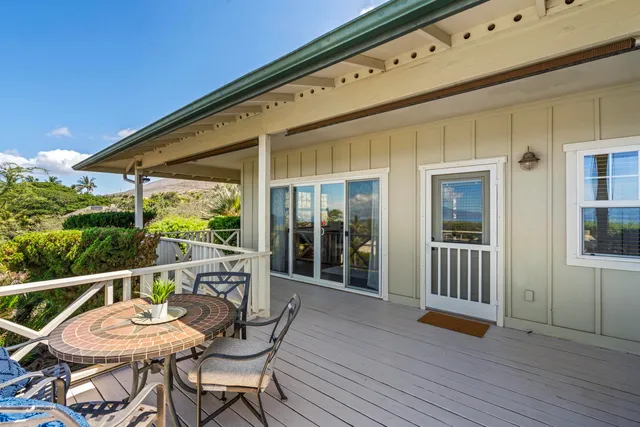 a balcony with table and chairs