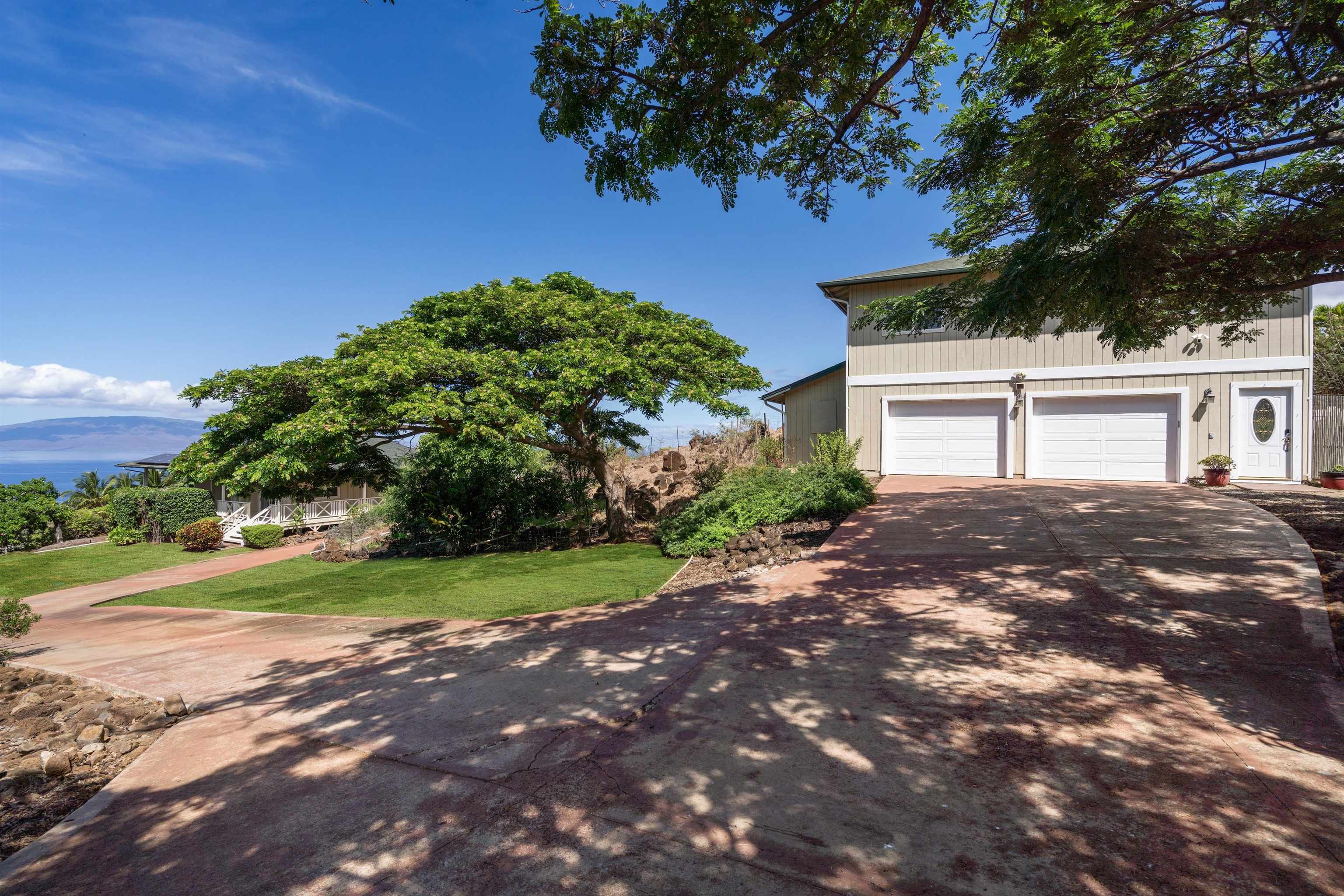 60 East Huapala Place, Unit B Lahaina, HI 96761 - Photo 28 of 50 a front view of a house with a yard and garage