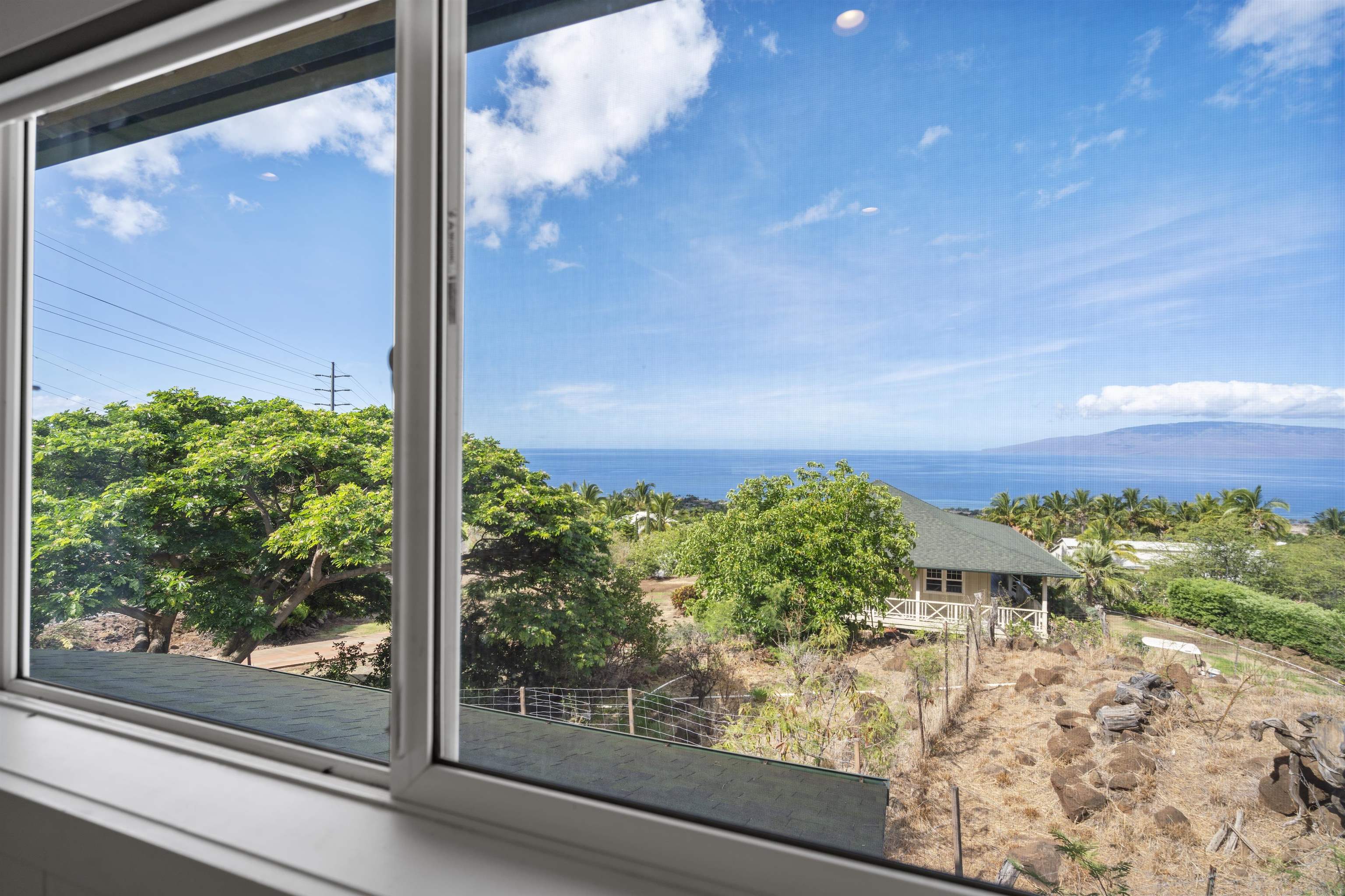 60 East Huapala Place, Unit B Lahaina, HI 96761 - Photo 32 of 50 a view of a window with a tree in front of it