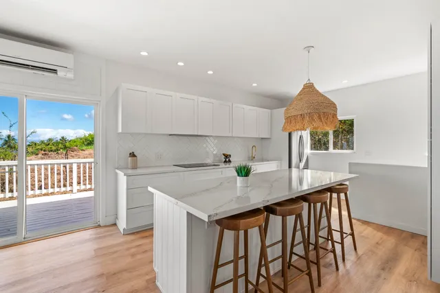 a kitchen that has a table and chairs in it