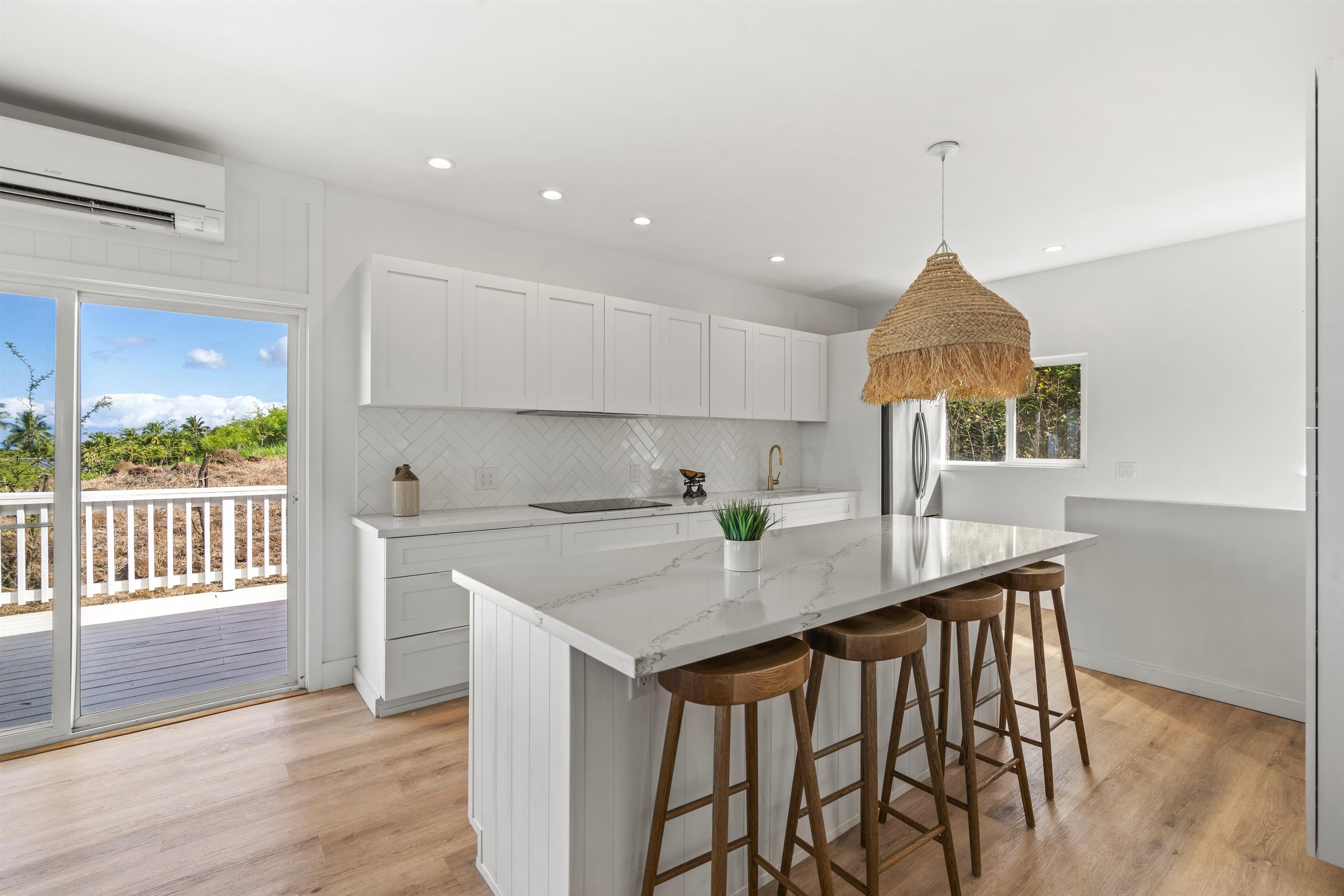 60 East Huapala Place, Unit B Lahaina, HI 96761 - Photo 34 of 50 a kitchen that has a table and chairs in it